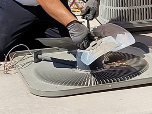 Technician Cleaning HVAC Coils and Fan